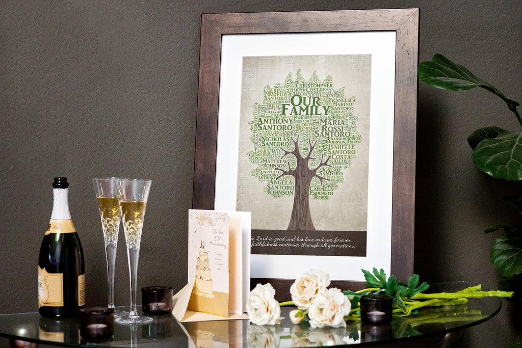 a framed personalized family tree gift sits on a table surrounded by roses and champagne for a golden 50th wedding anniversary